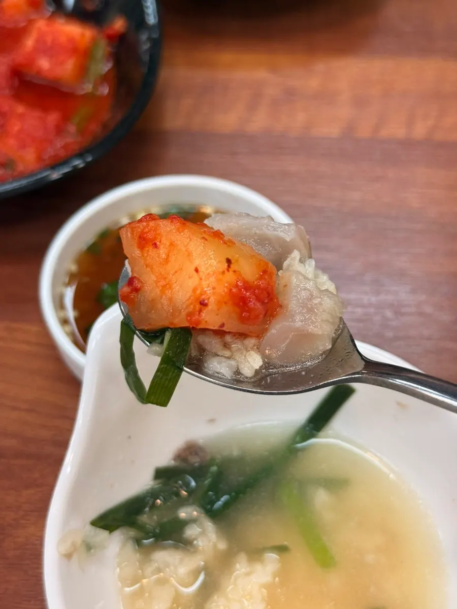 A spoonful of scorched rice eaten with diced radish kimchi