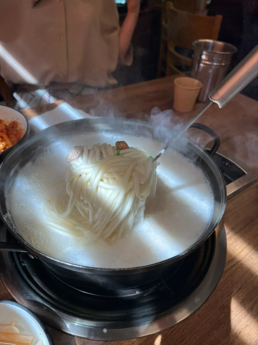 Table set with kalguksu and side dishes