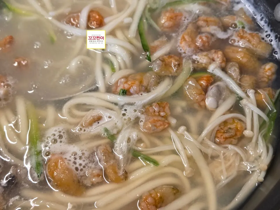 Seafood kalguksu with clams, oysters, and omandungi