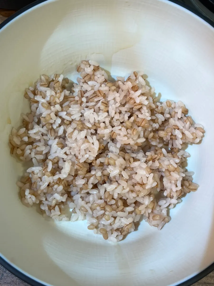 A bowl of barley rice topped with bean sprouts