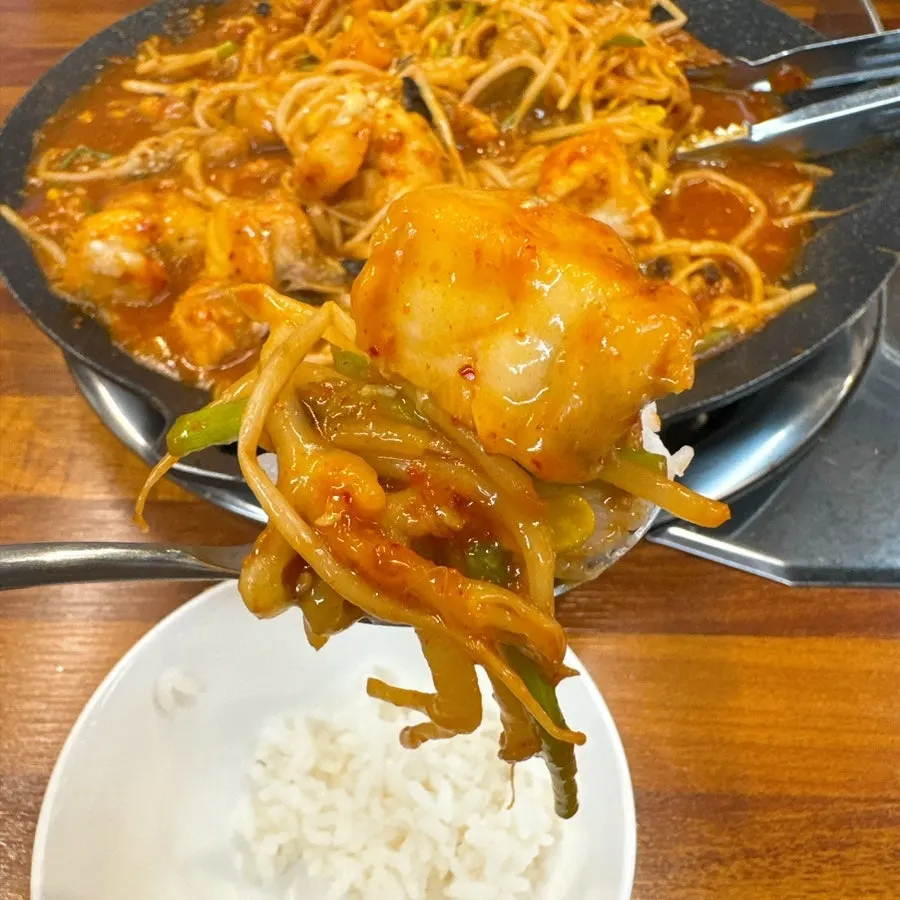 A bite of monkfish with bean sprouts