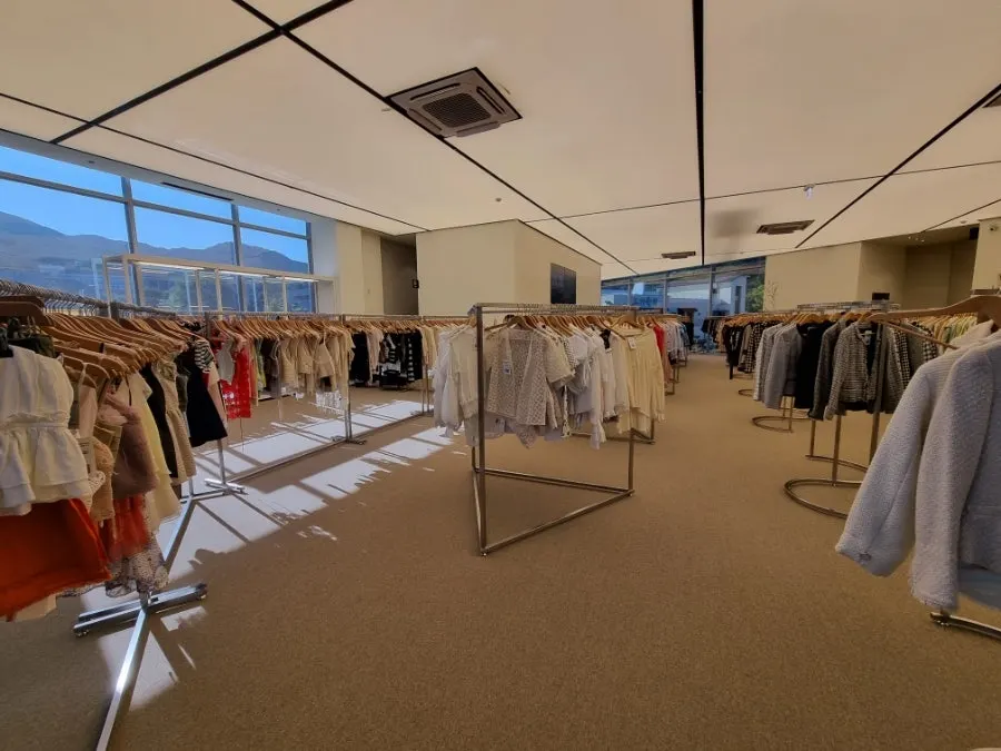 Second-floor store with rows of women's clothing racks