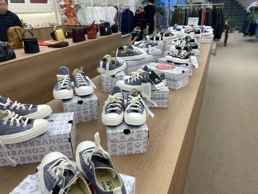 Clothing organized by brand on hangers