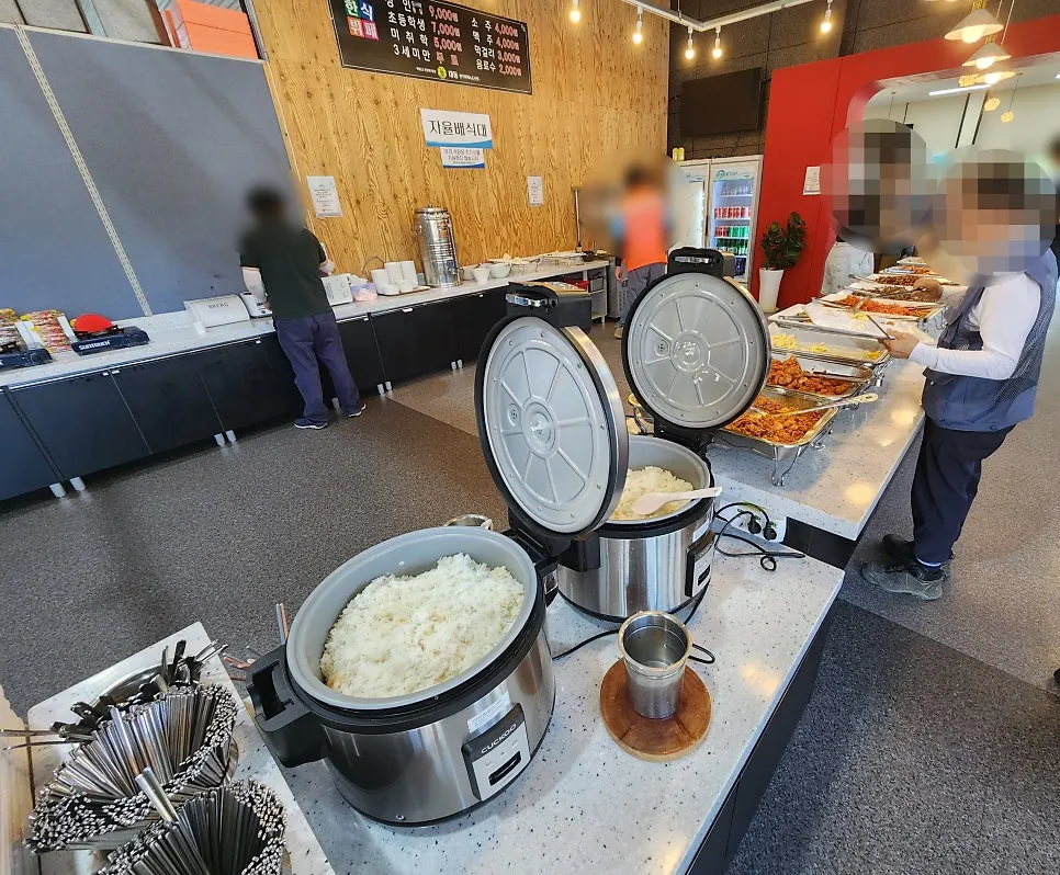 Pay-first counter near the entrance with trays and utensils