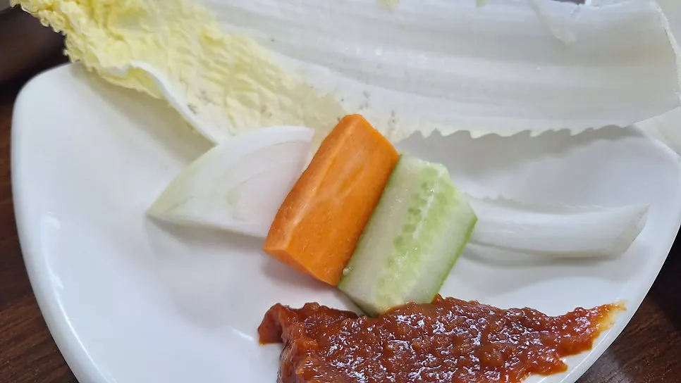Picking apart a piece of braised galchi