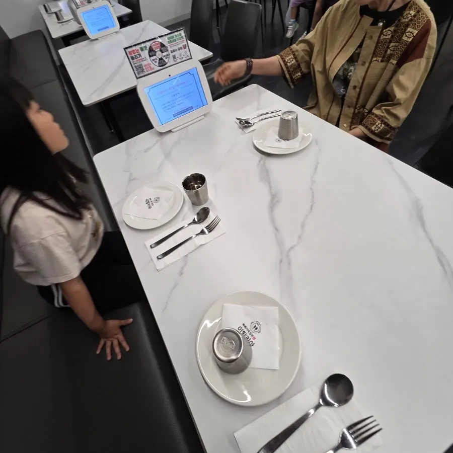 Utensils and cups set on a white table