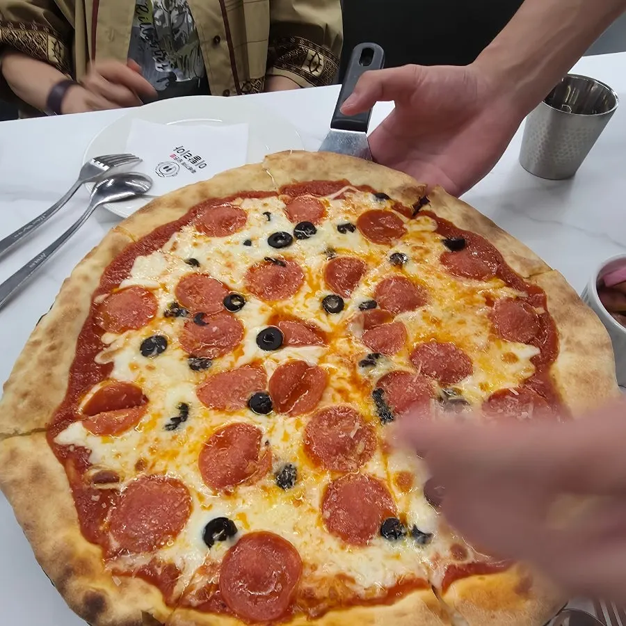 Large pepperoni pizza set on the table