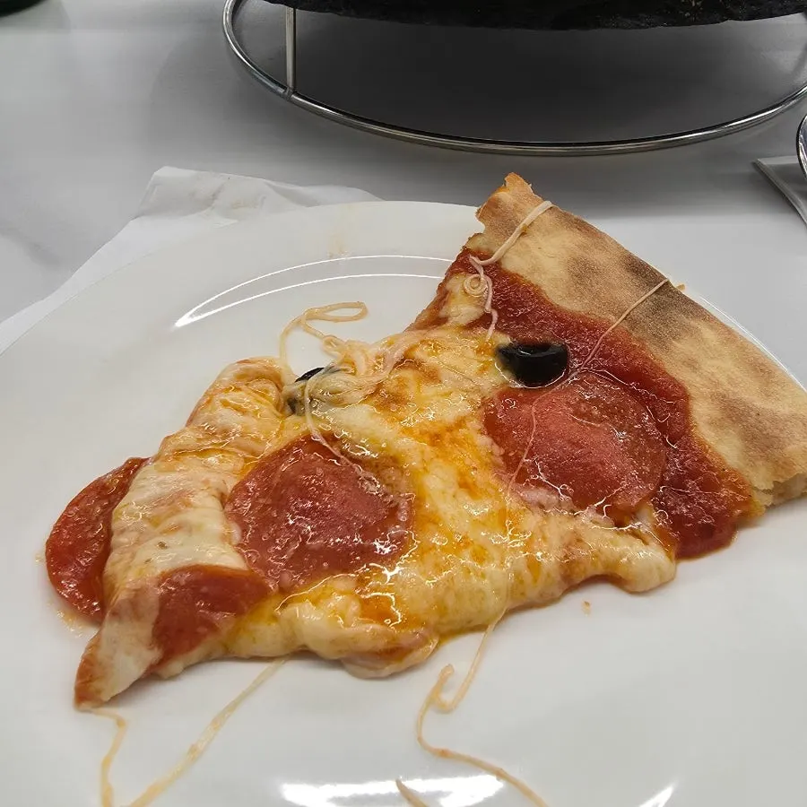 Oven pepperoni pizza cut into multiple slices