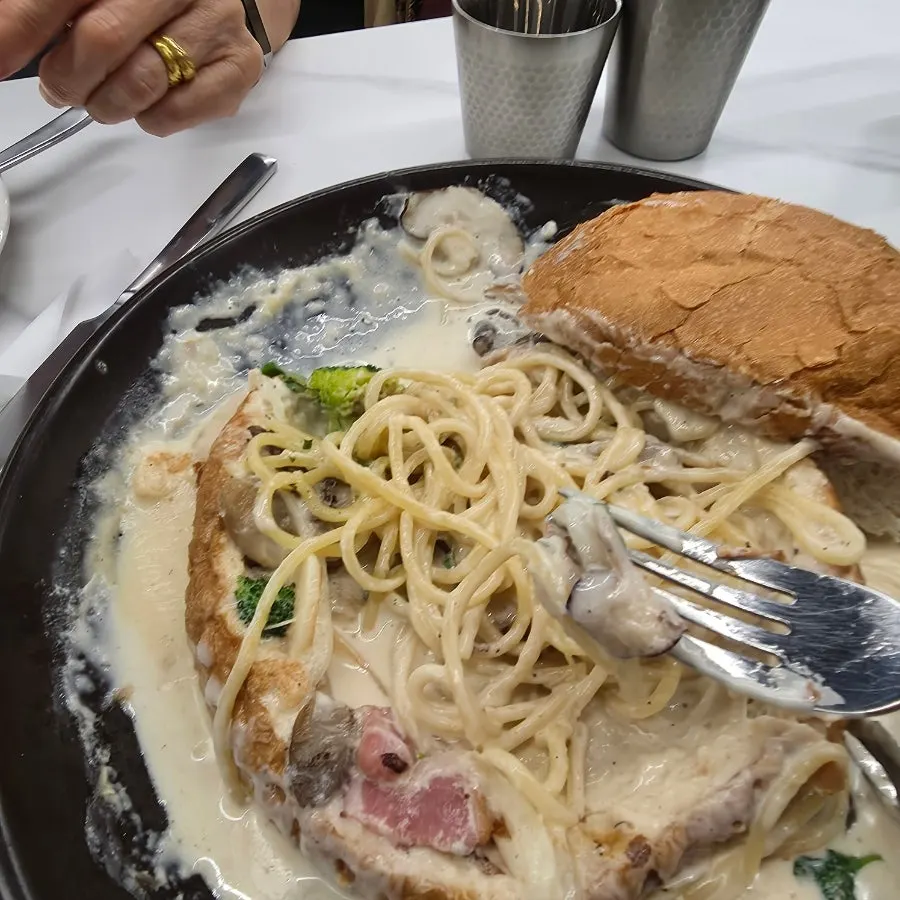 Table set with both pizza and cream pasta