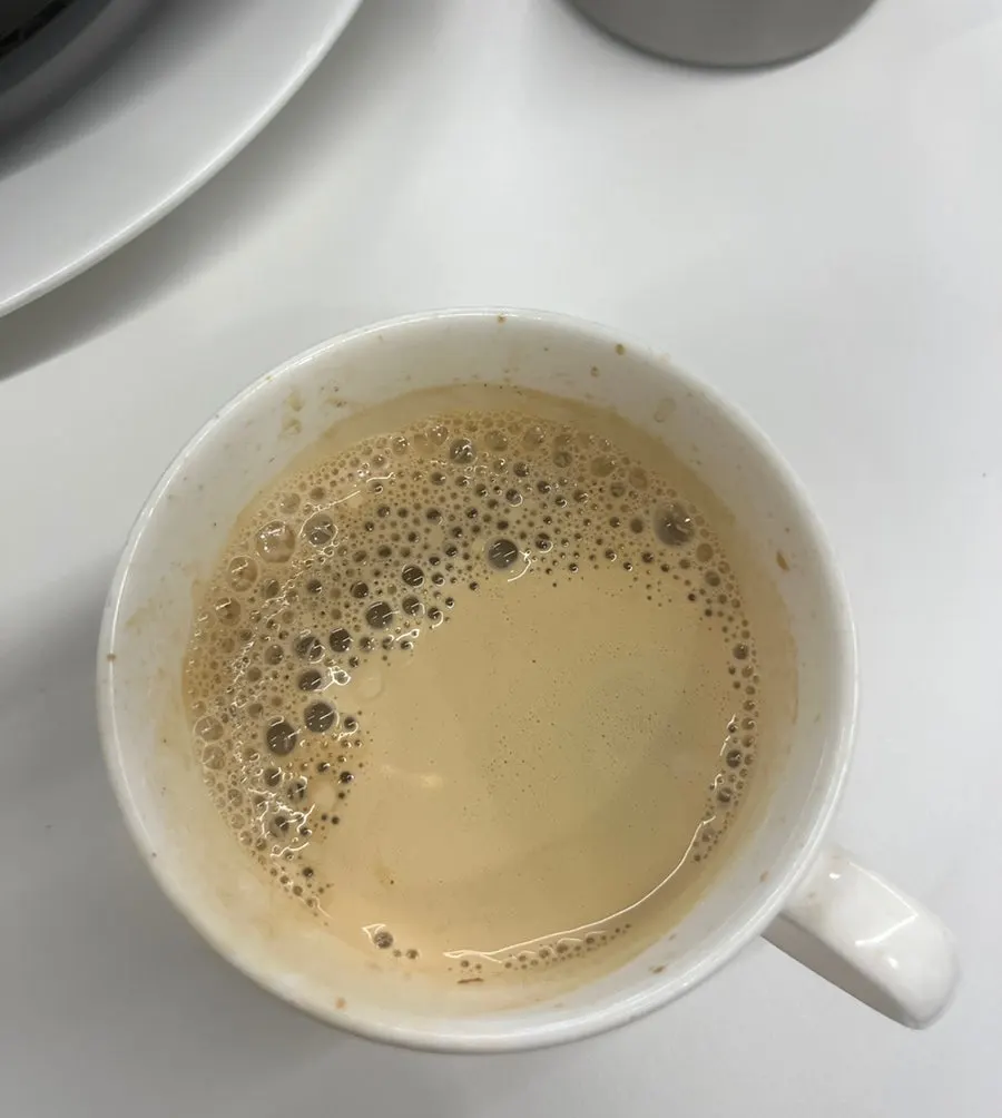 Warm americano poured at the self-serve corner