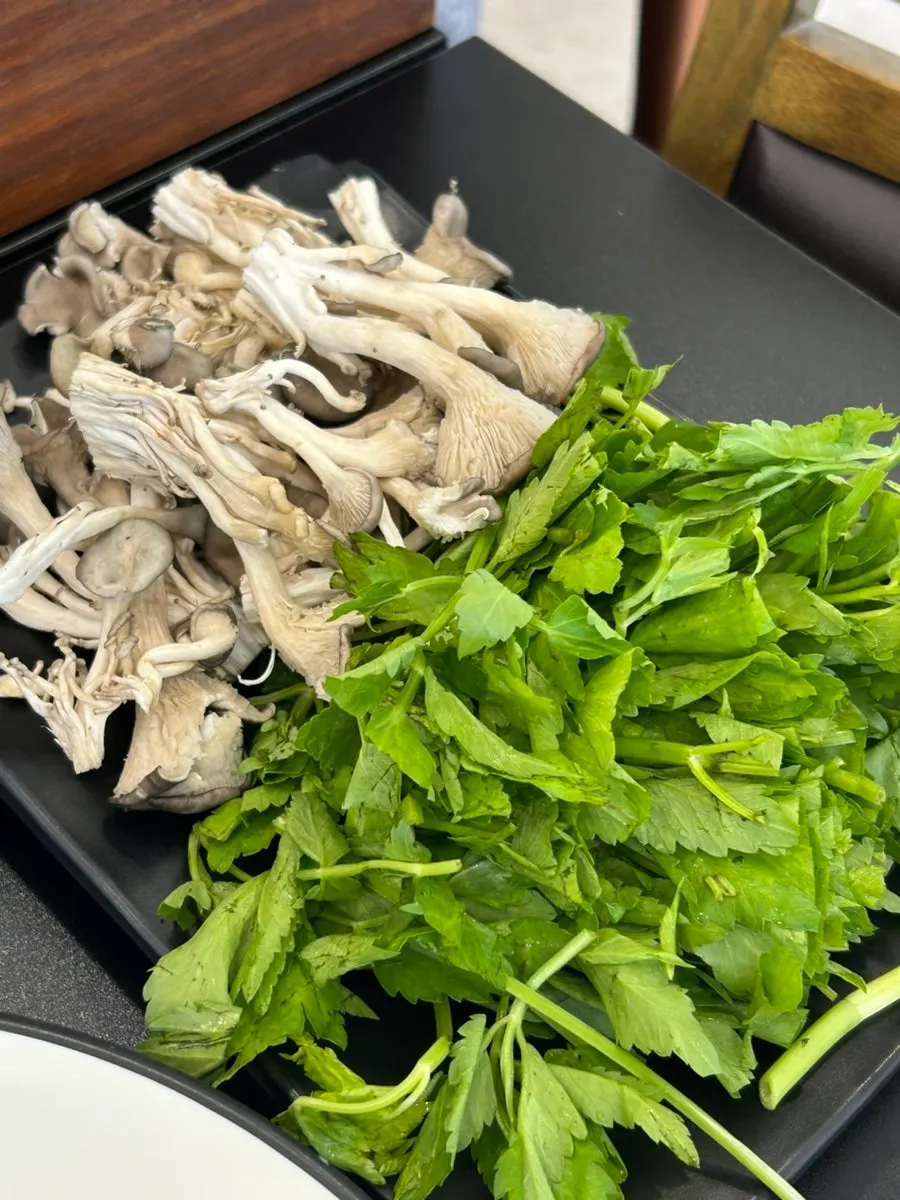 Flat kalguksu with meat, minari, and mushrooms