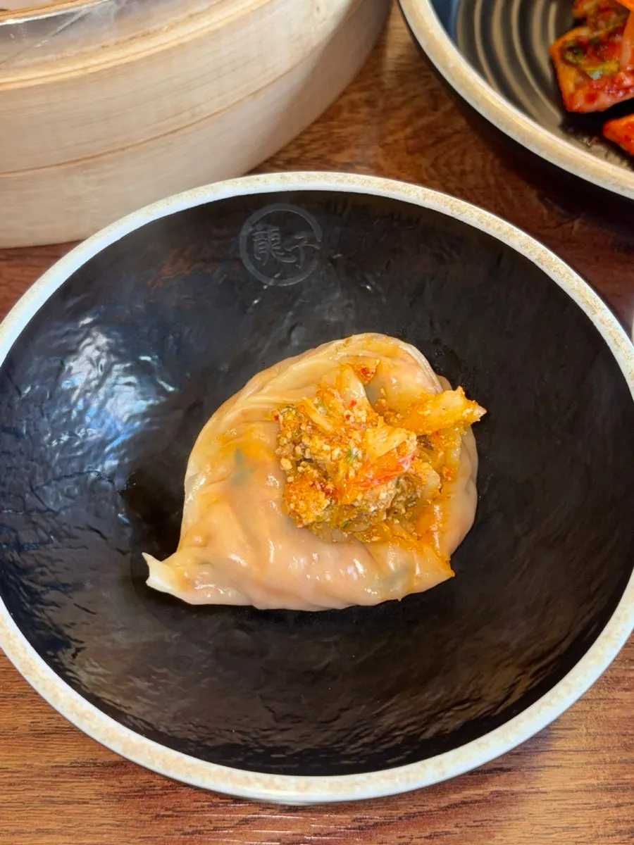 Thin skin revealing the packed kimchi dumpling filling
