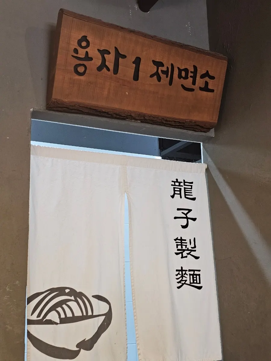 Kitchen scene with dumplings being pleated and noodles being cut