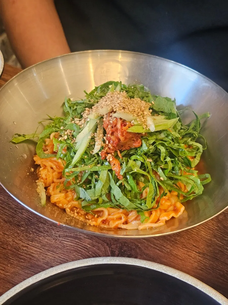 Bibim kalguksu piled high with perilla leaves