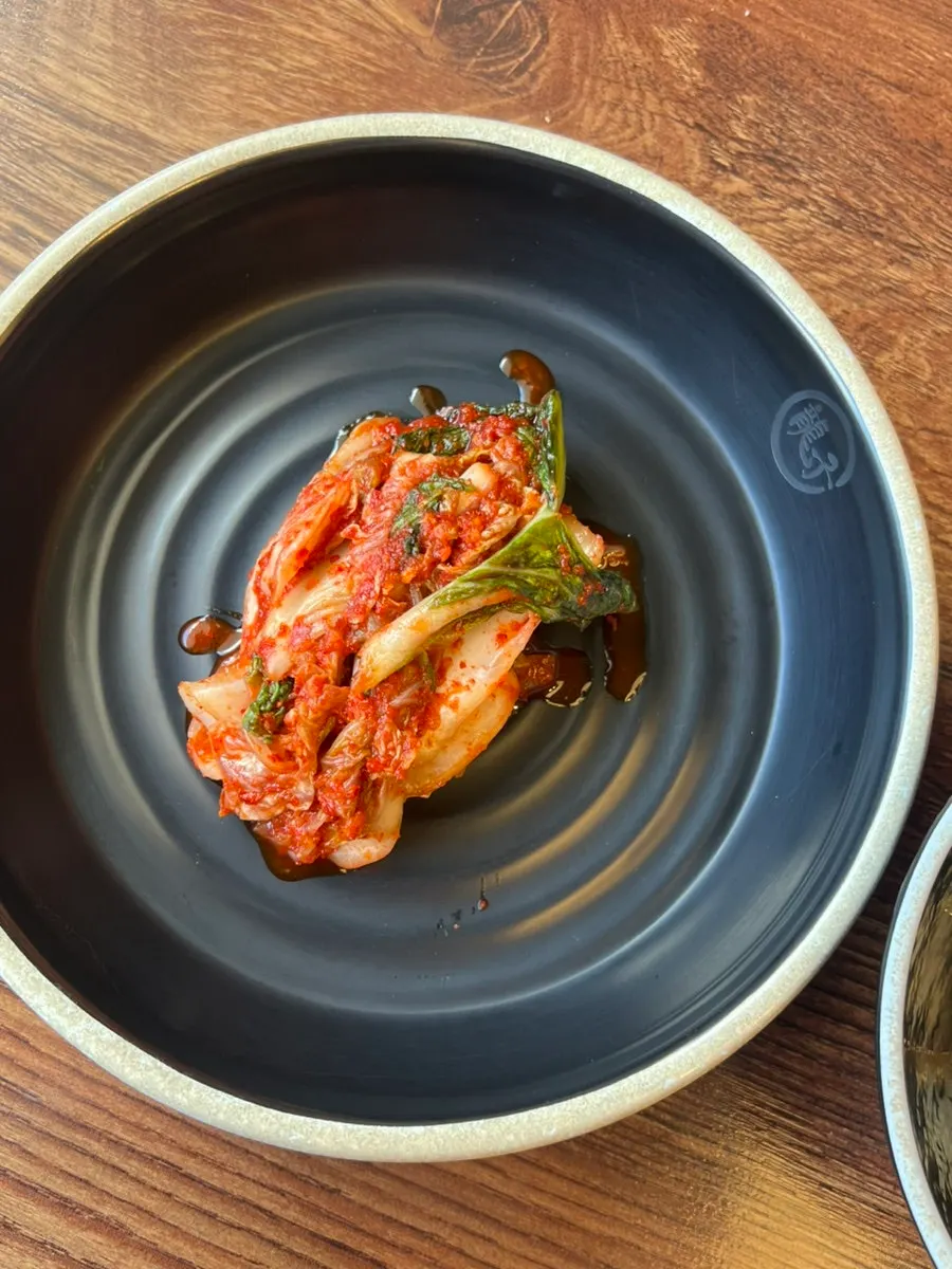 Table setting with kong-kalguksu, kalmandu-guk and steamed dumplings
