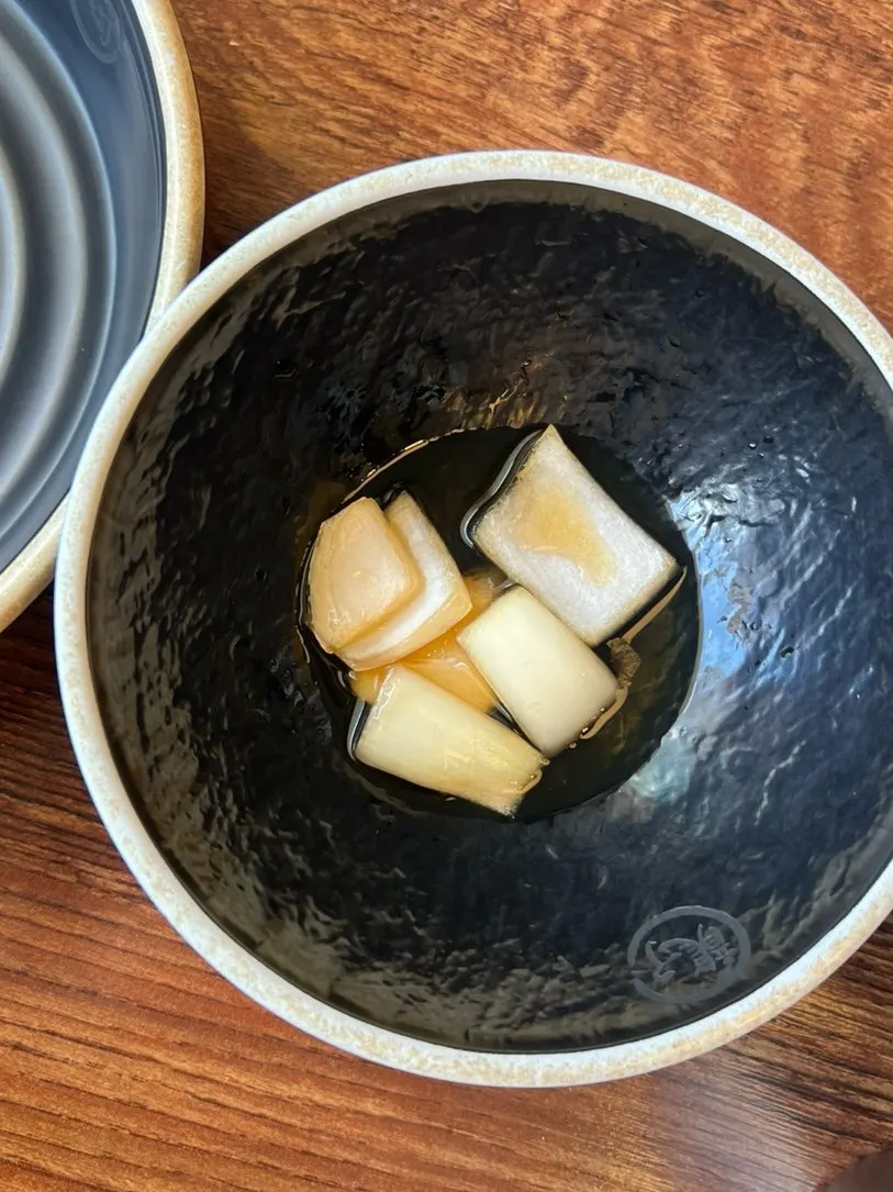 Two bowls of noodles and a plate of dumplings ordered for two
