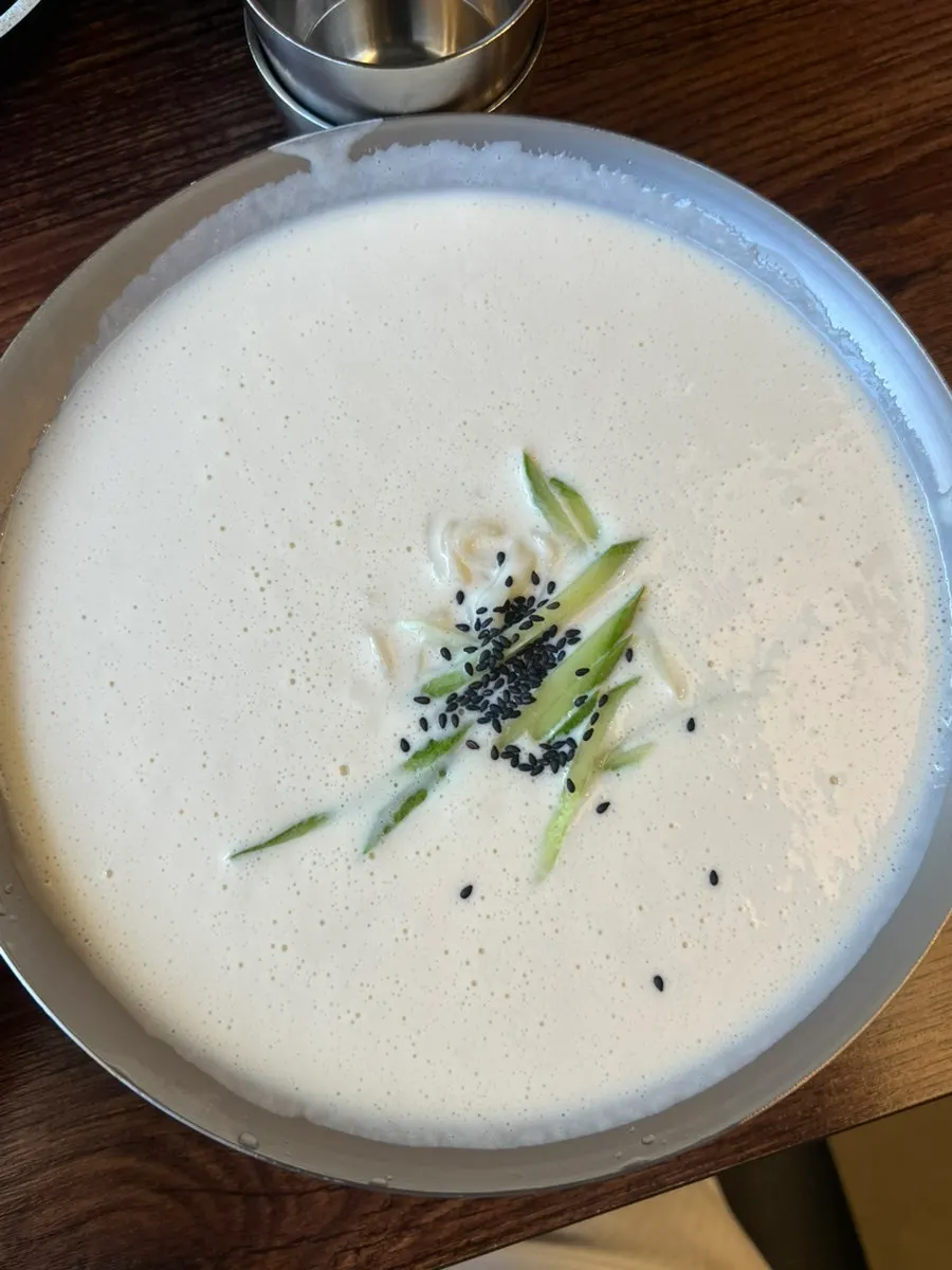 Table piled with generous portions of kalguksu and dumplings