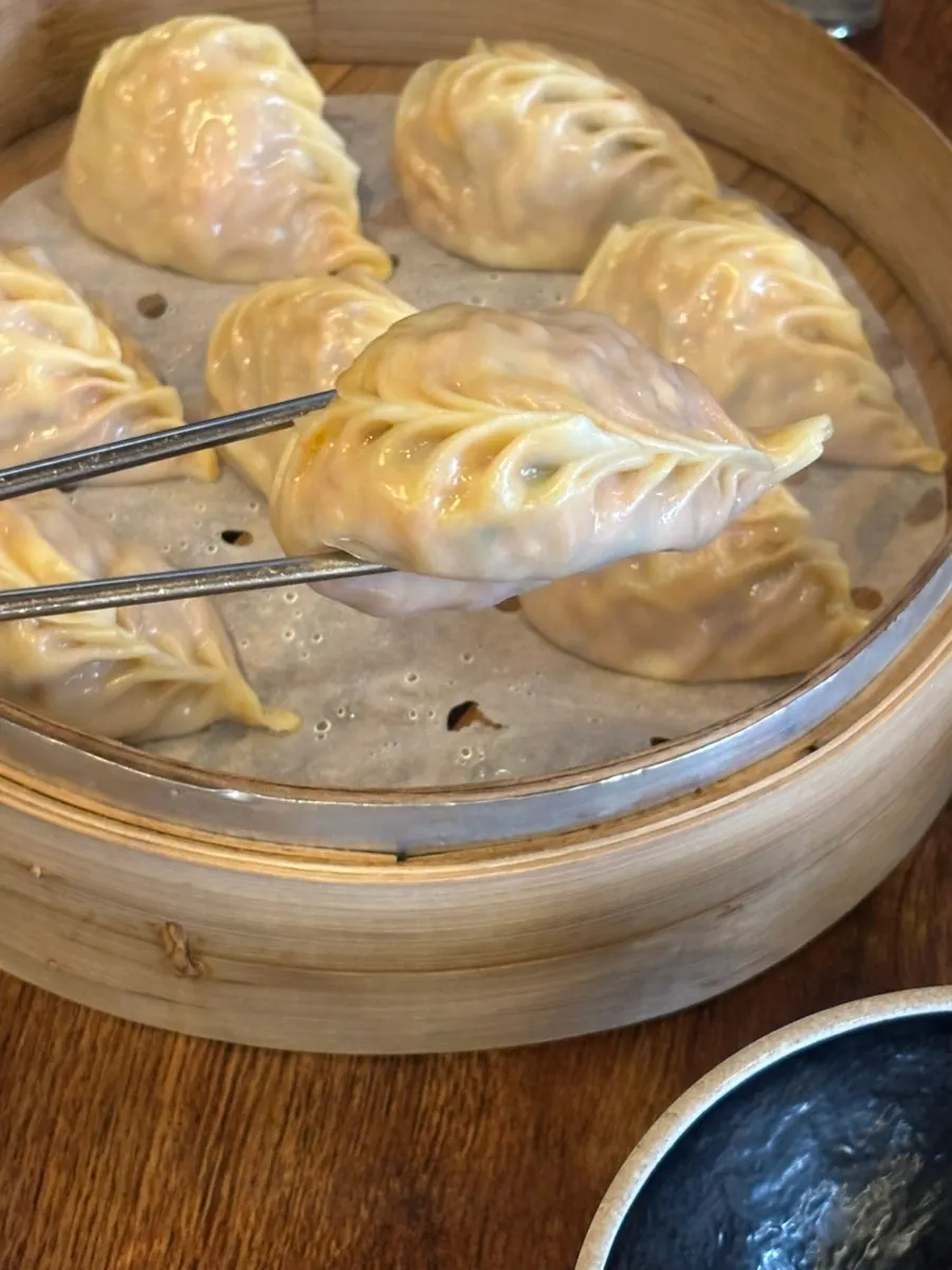Open window showing dumplings being hand-made