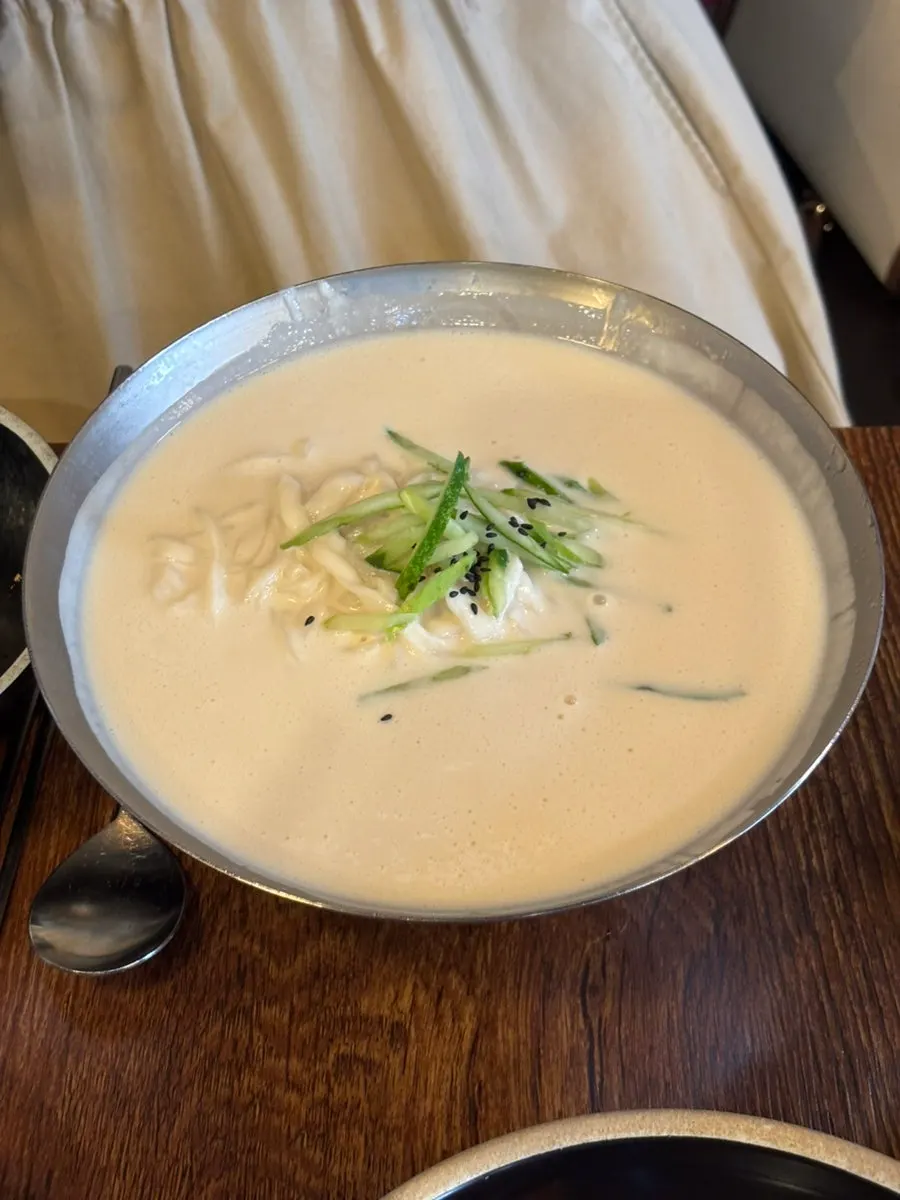 Close-up of noodles in the rich kalguksu broth