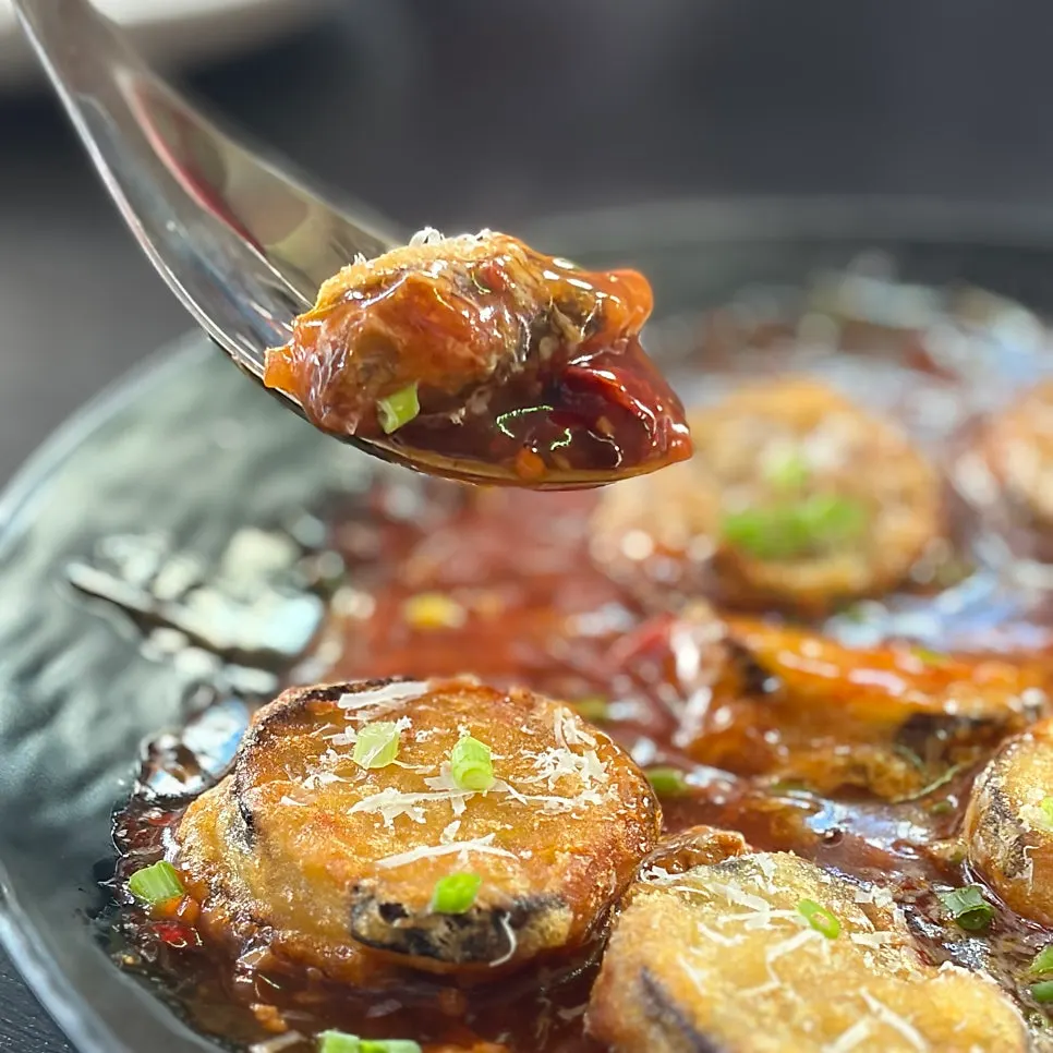 Close-up of the fish-tank eggplant fritters with sauce