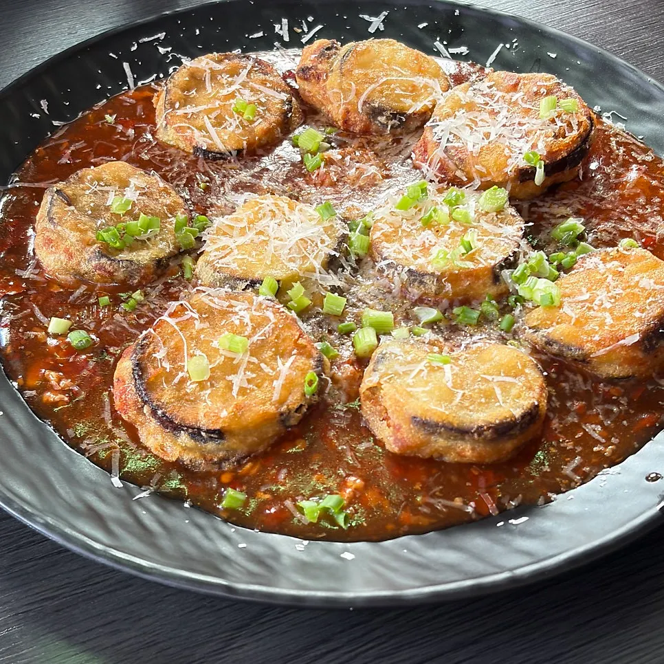 Cross-section showing the crispy-outside, tender-inside texture of the eggplant fritters