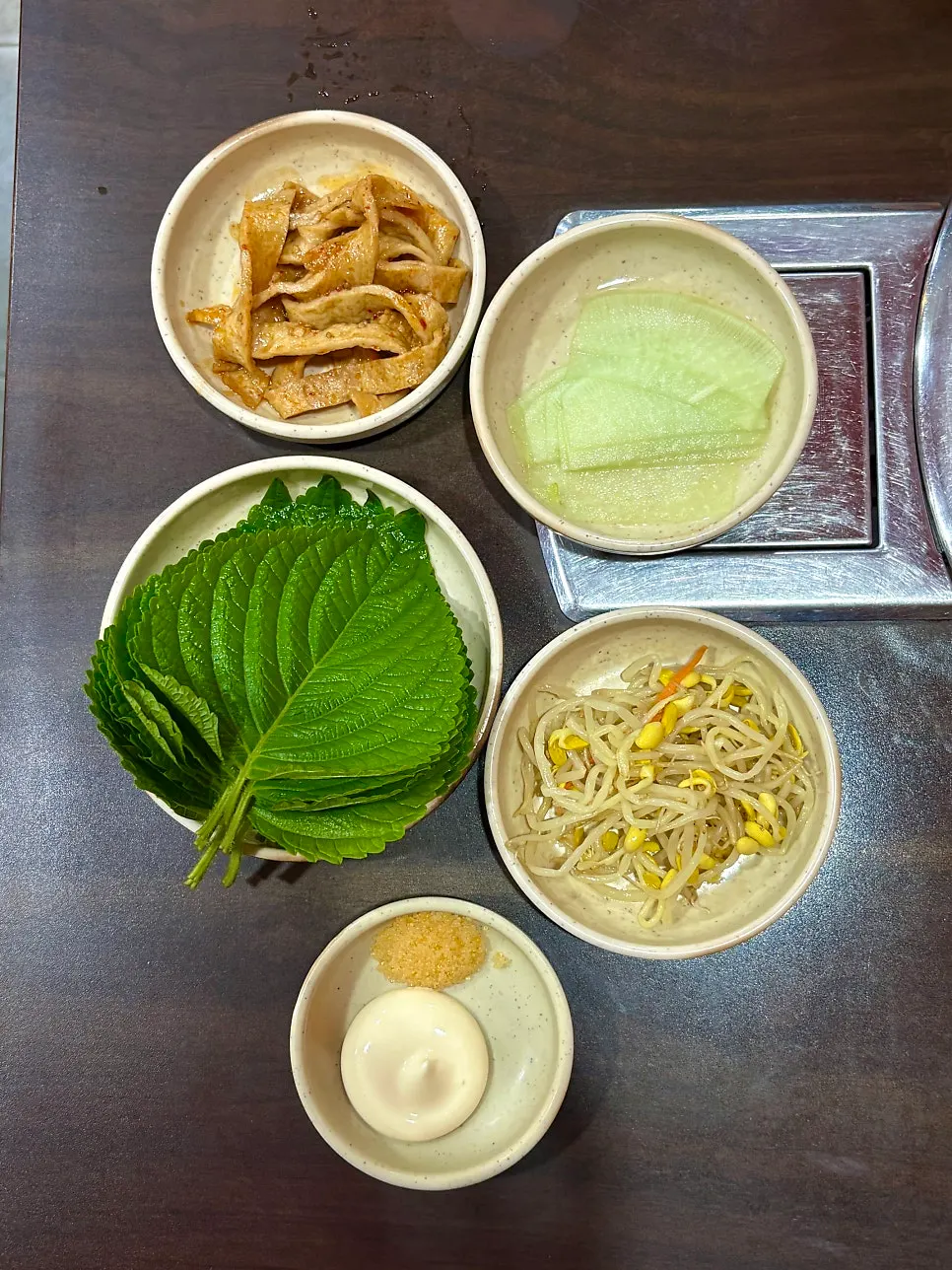 Basic side dishes including pickled radish, stir-fried fish cake, and bean sprouts