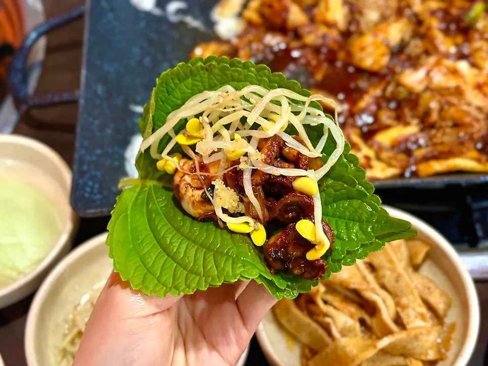 A bite of octopus paired with bean sprouts