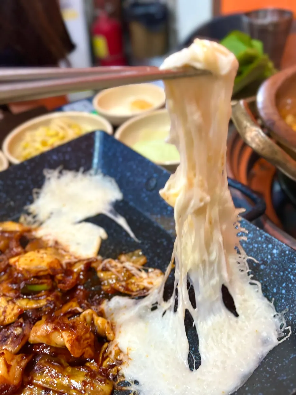 A bite of octopus coated in melted cheese