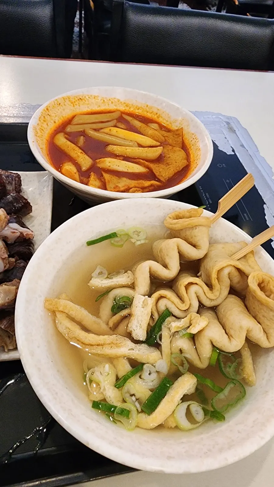 Skewered fish cake soup with fried tofu and green onion
