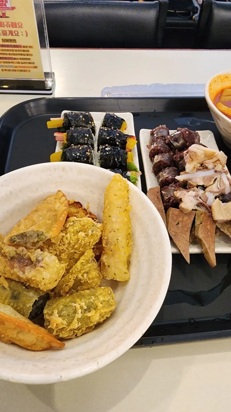 Piece of fritter dipped into tteokbokki broth