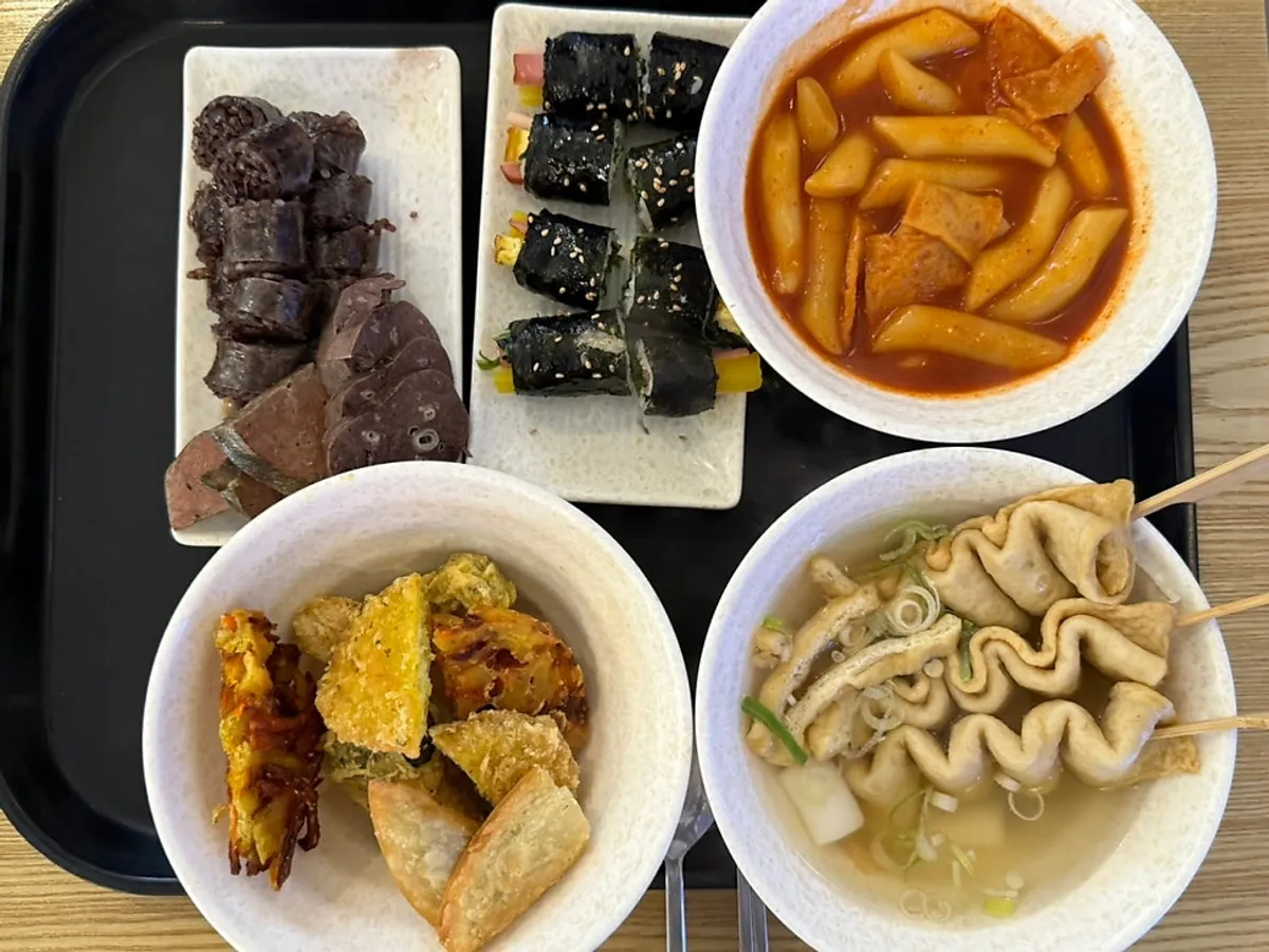 Hyeonseon Combo with sundae, gimbap, tteokbokki, fritters, and fish cakes