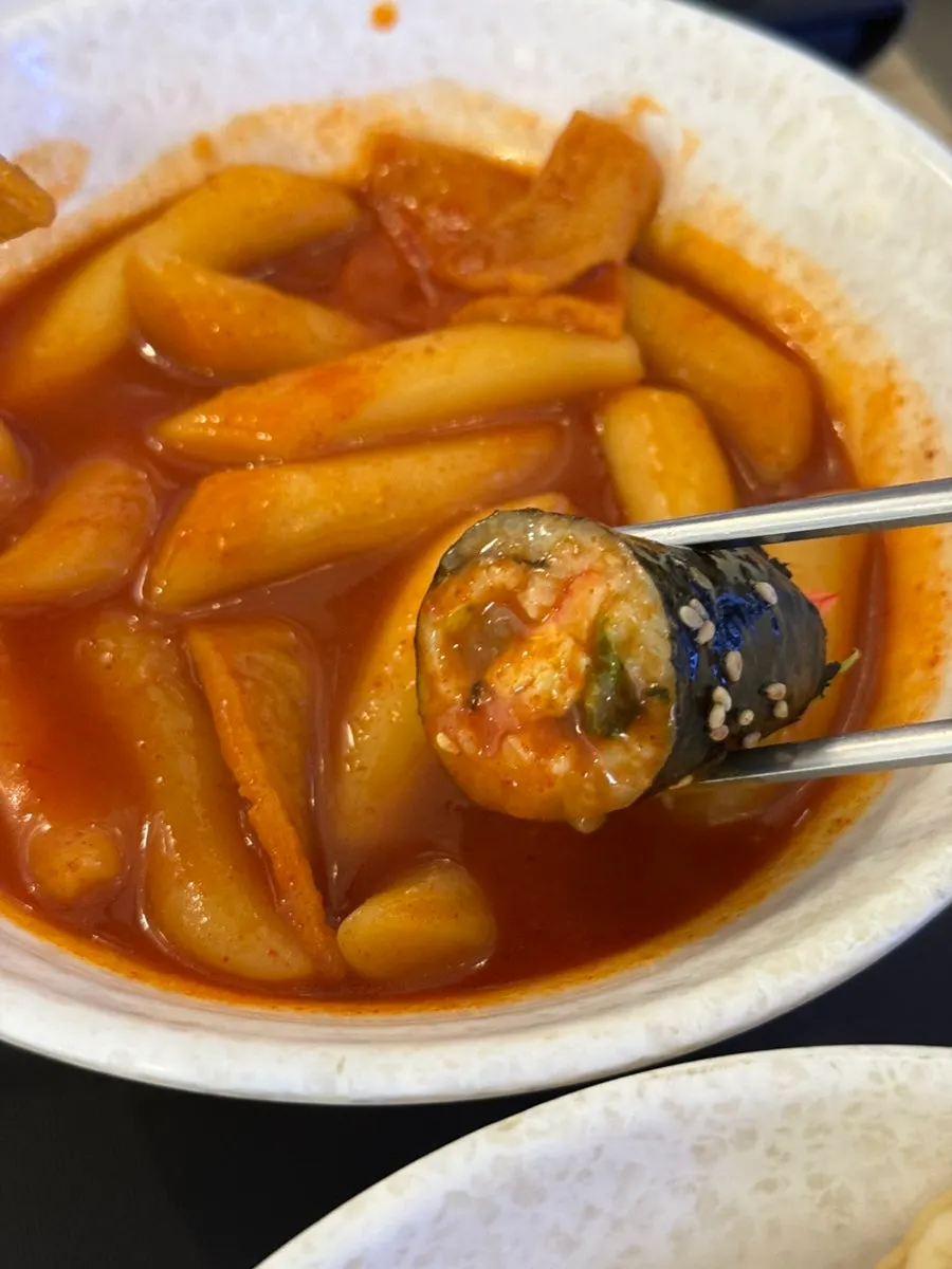 Gimbap dipped in tteokbokki sauce