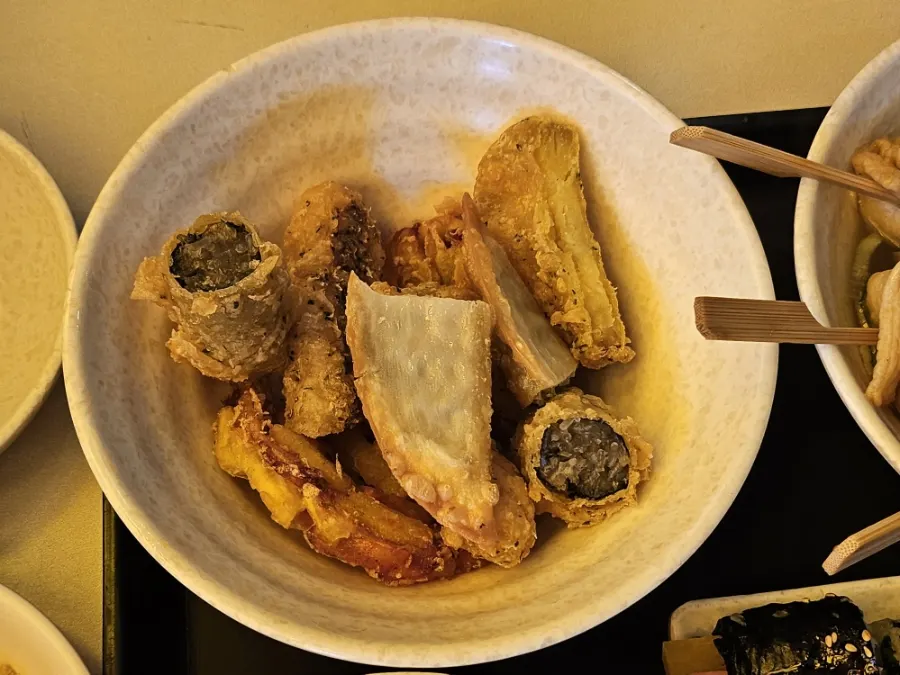 Assorted fried seaweed rolls, sweet potato, dumplings, and vegetables