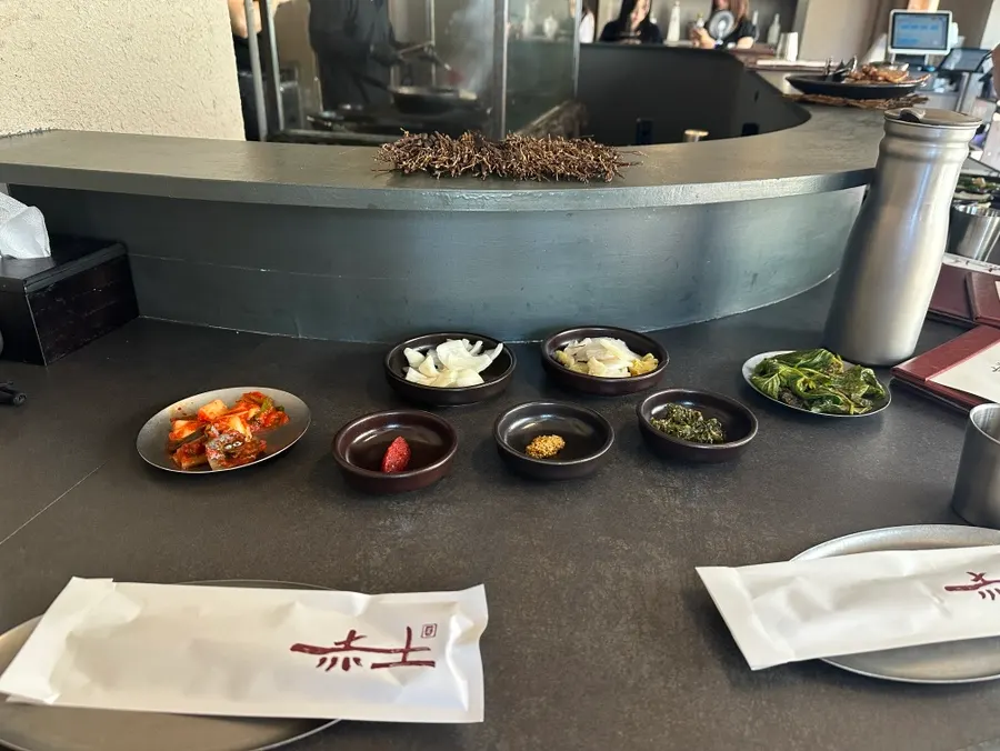 Staff initially grilling meat over charcoal