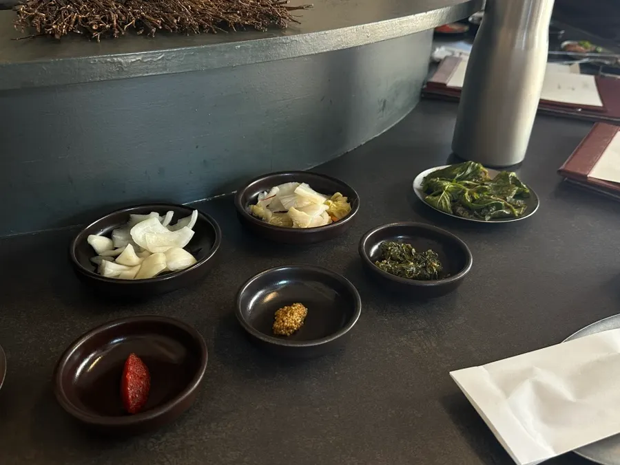 Meat being initially grilled in front of the counter seats
