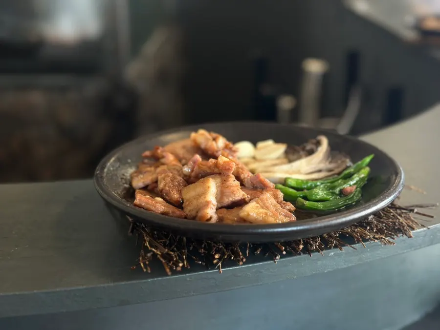 Fermented pork served with shishito peppers