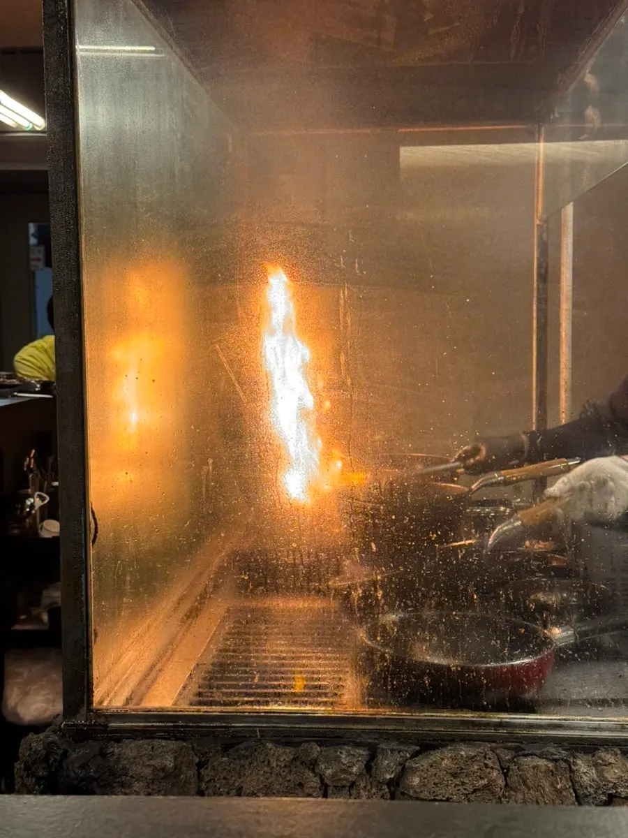 Cooking process in front of the counter seats