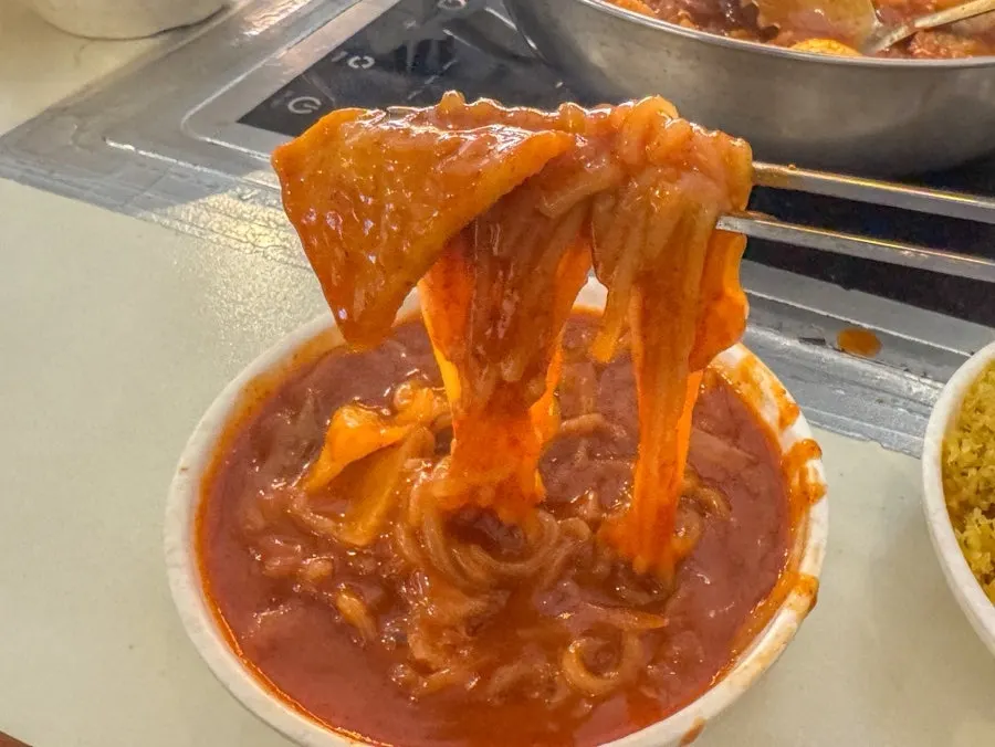Tteokbokki and mandu served onto an individual plate
