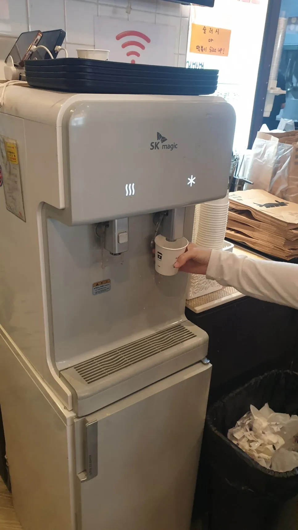 Self-serve water dispenser corner with water and aprons
