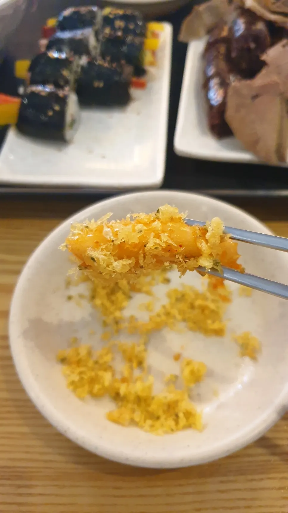 A chewy rice cake picked up with chopsticks