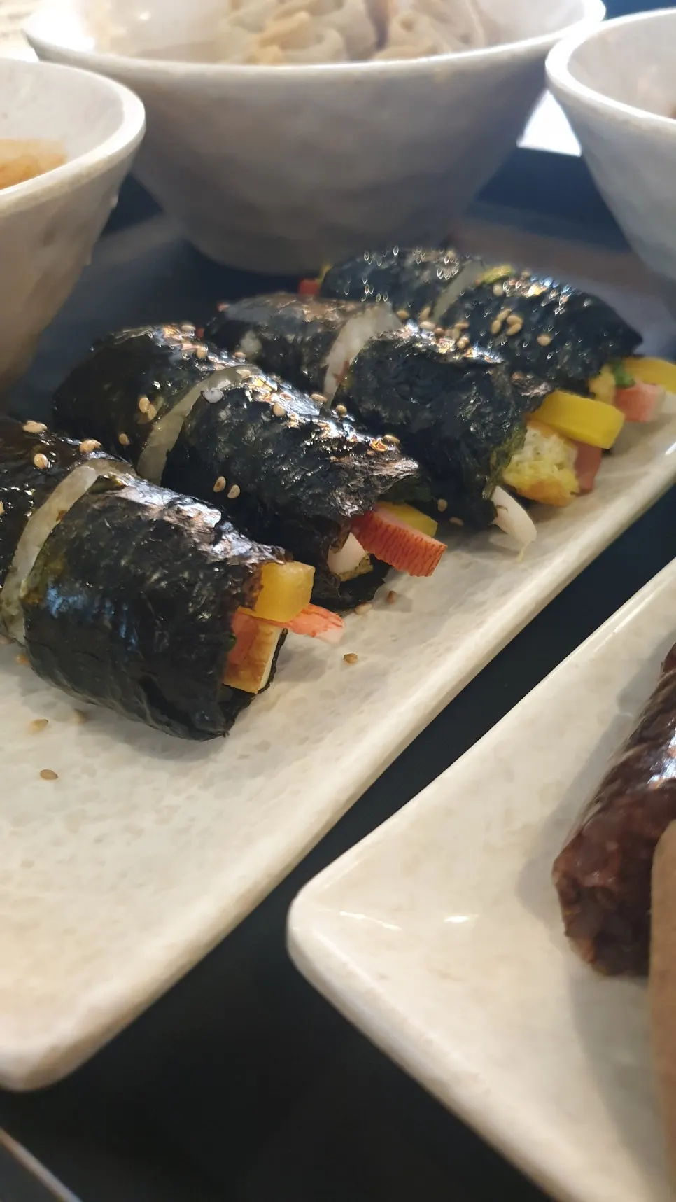 A plate of mini gimbap packed with filling