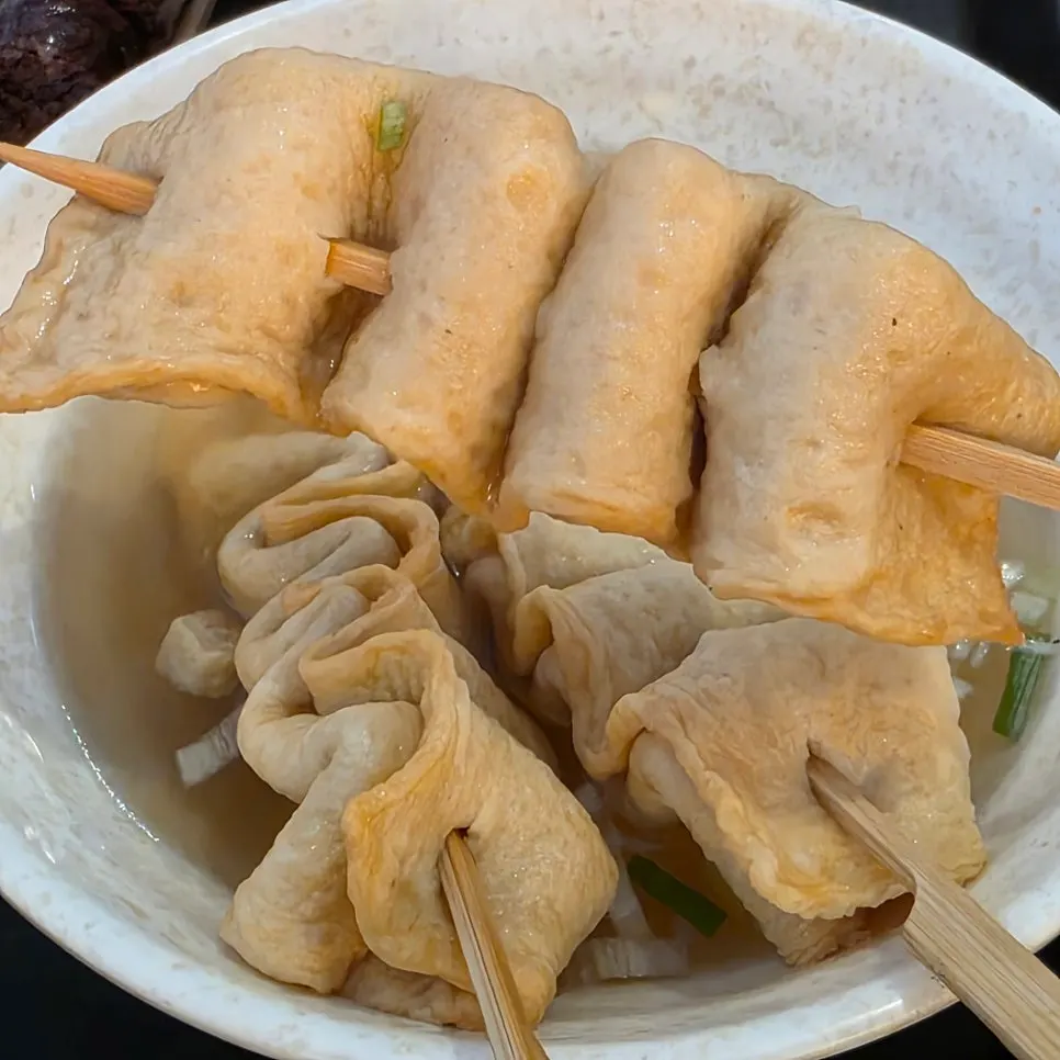 Fried snacks dipped in tteokbokki sauce