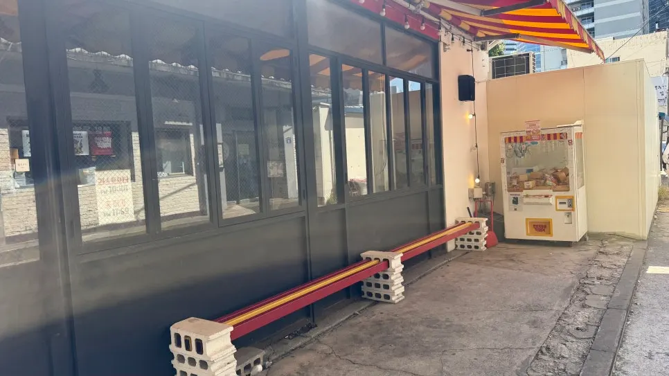 Waiting bench and claw machine out front