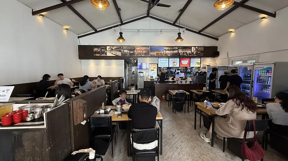 Restaurant interior with tables and kitchen visible