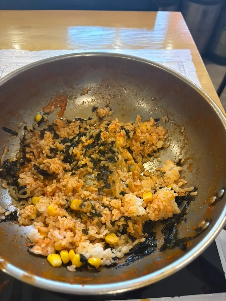 Fried rice topped with corn kernels and seaweed flakes