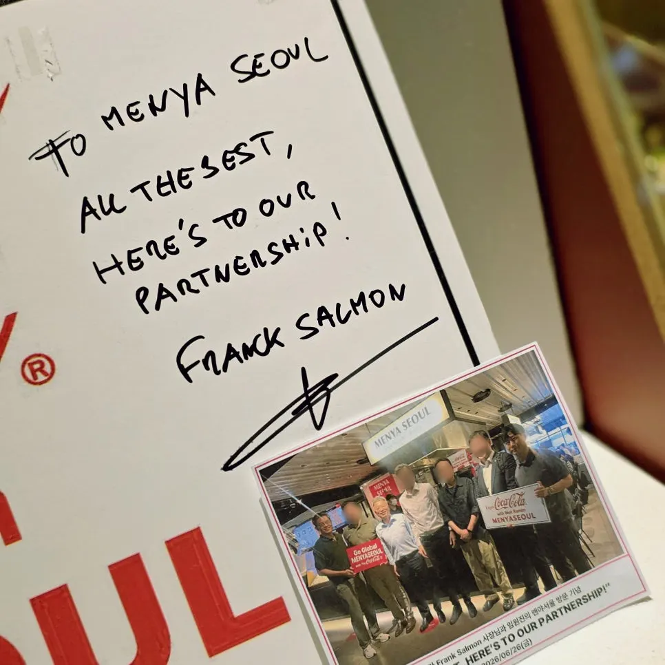 Sign about the Menya Seoul and Coca-Cola partnership