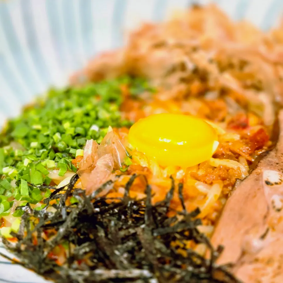 Ramen noodles lifted with chopsticks