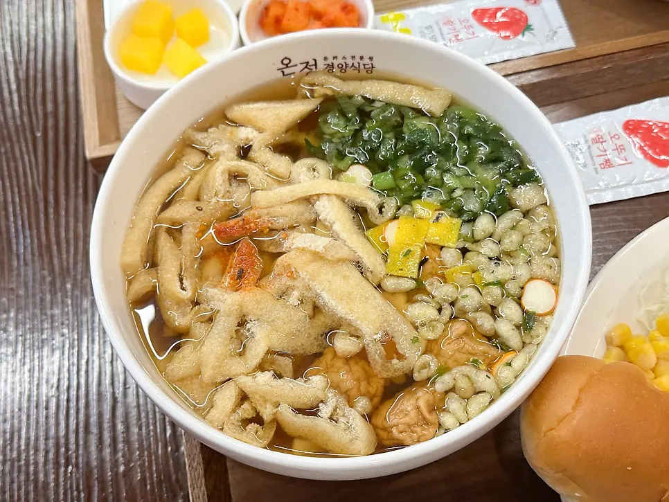 Pork cutlet spread with morning bread, salad, rice, and corn kernels