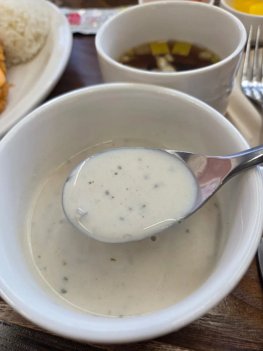 Dipping the dinner roll into the mushroom soup
