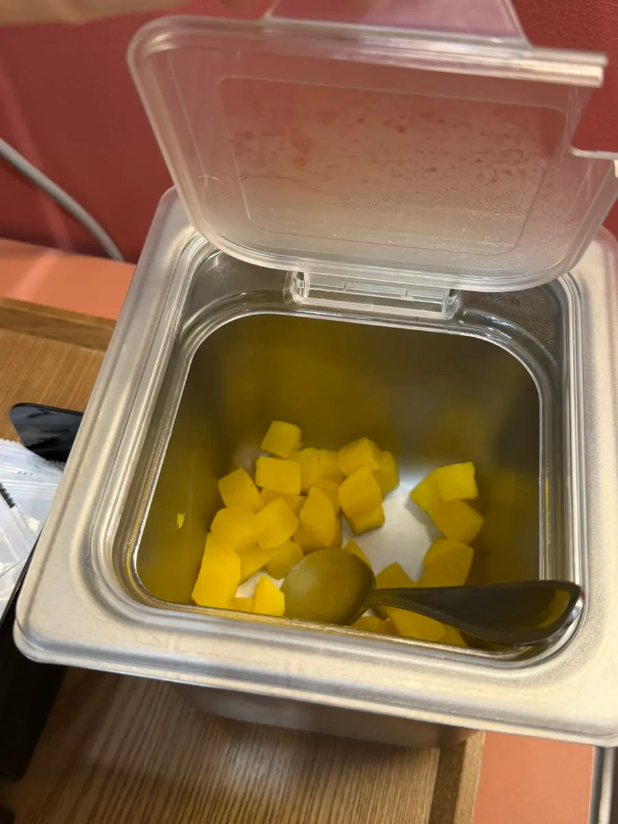 Diced radish kimchi and side dish containers at the self-serve bar